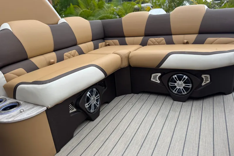 Slide: The Image of Luxurious seating on 2026 Avalon Excalibur 27' boat with integrated speakers and cup holders. - 32