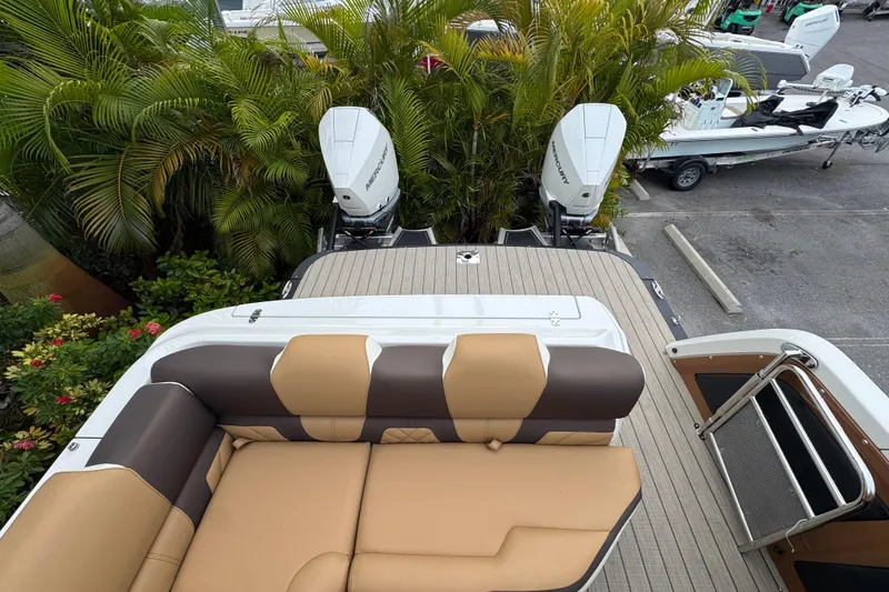 Slide: The Image of 2026 Avalon Excalibur 27' boat with tan seating and dual Mercury outboard engines. - 37