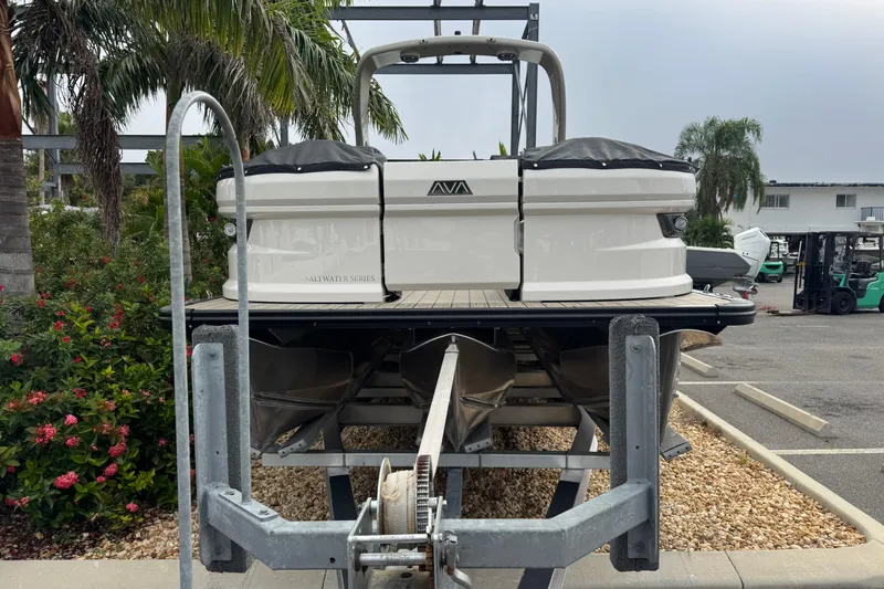 Slide: The Image of 2026 Avalon Excalibur 27' boat on trailer, surrounded by tropical plants. - 4