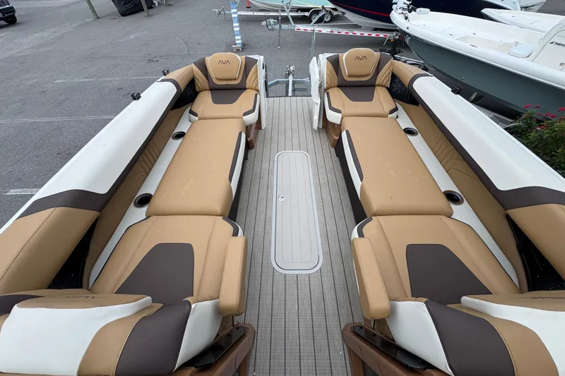 Slide: The Image of Luxurious seating on 2026 Avalon Excalibur 27' boat, featuring tan and brown upholstery. - 49