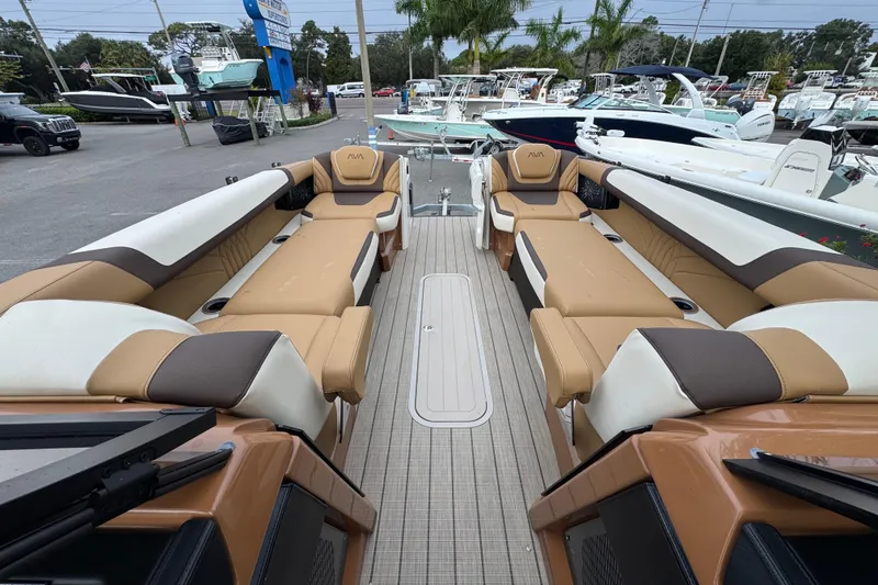 Slide: The Image of Luxurious 2026 Avalon Excalibur 27' boat interior with tan and white seating. - 50