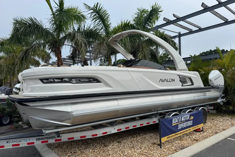 Slide: The Image of 2026 Avalon Excalibur 27' boat on trailer, surrounded by palm trees. - 9