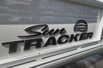 Slide: The Image of Sun Tracker Party Barge 16 DLX 2026 logo close-up. - 2