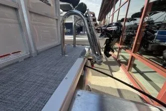 Slide: The Image of Sun Tracker Party Barge 16 DLX 2026 with motor and ladder. - 8