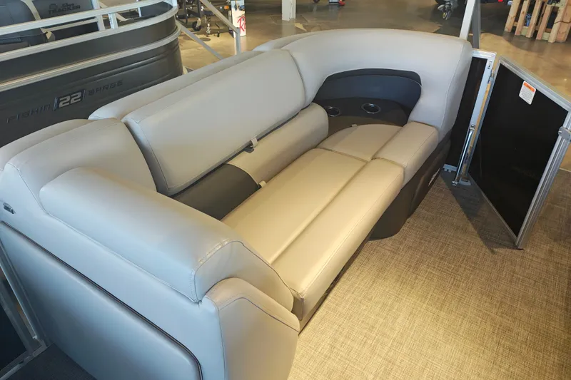 Slide: The Image of 2026 Sun Tracker Party Barge 20 DLX interior seating, featuring plush beige upholstery. - 19