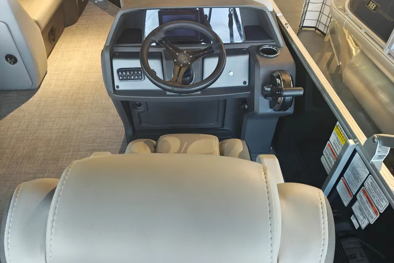 Slide: The Image of 2026 Sun Tracker Party Barge 20 DLX helm with steering wheel and controls. - 15