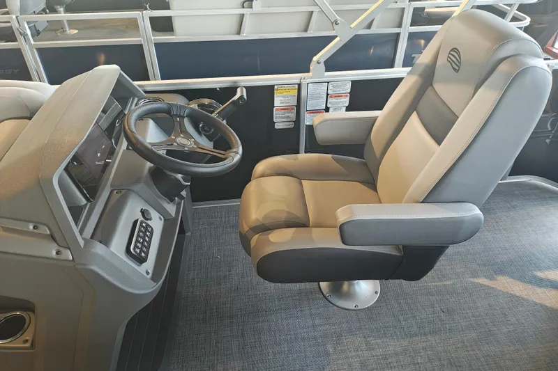 Slide: The Image of 2026 Sun Tracker Party Barge 20 DLX helm with comfortable captain's chair and steering console. - 16