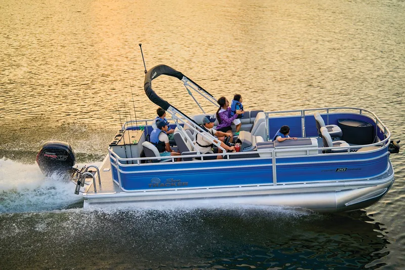 The Image of 2026 Sun Tracker Fishin' Barge 20 DLX pontoon boat at Bass Pro Shops entrance. - 0