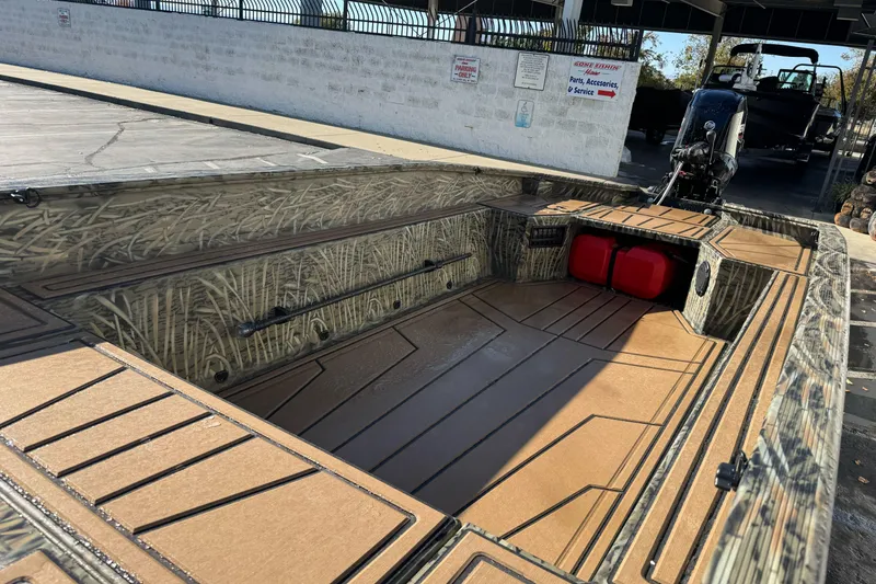 Slide: The Image of 2026 Tracker Grizzly 1650 T Prairie Wings Edition boat interior with camouflage design. - 10