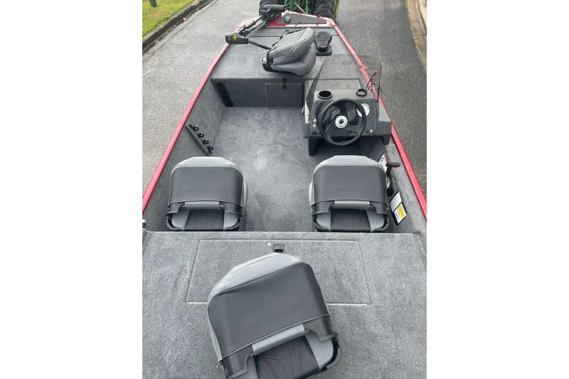 Slide: The Image of 2026 Tracker Bass Tracker Classic XL boat interior with seating and steering console. - 3