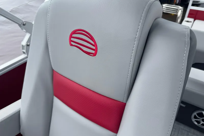 Slide: The Image of 2026 Sun Tracker Party Barge 22 RF DLX seat with red and gray upholstery. - 11