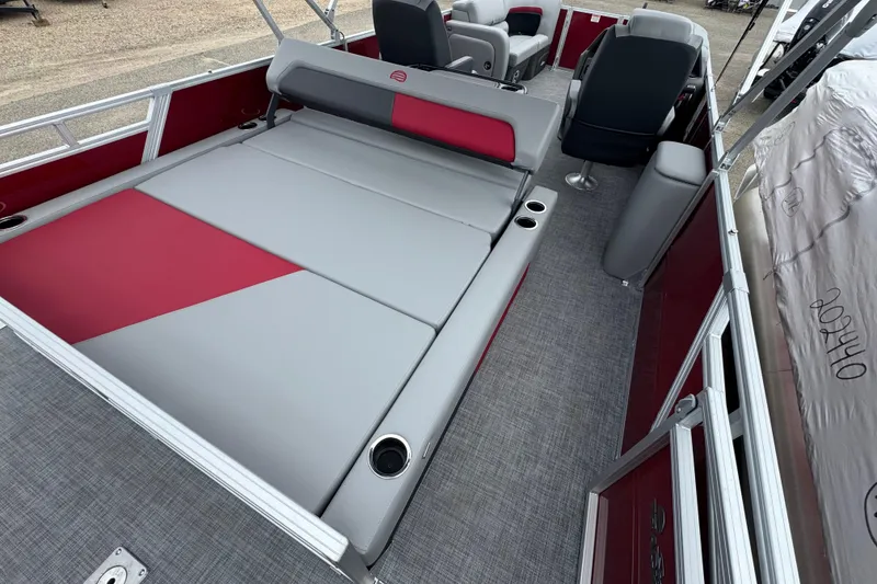 Slide: The Image of 2026 Sun Tracker Party Barge 22 RF DLX interior with gray and red seating. - 14