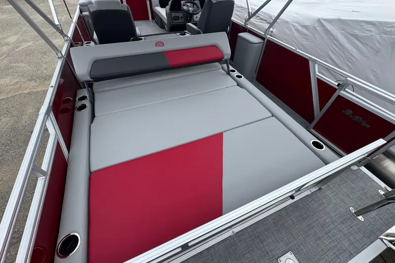 Slide: The Image of 2026 Sun Tracker Party Barge 22 RF DLX interior with red and gray seating. - 15