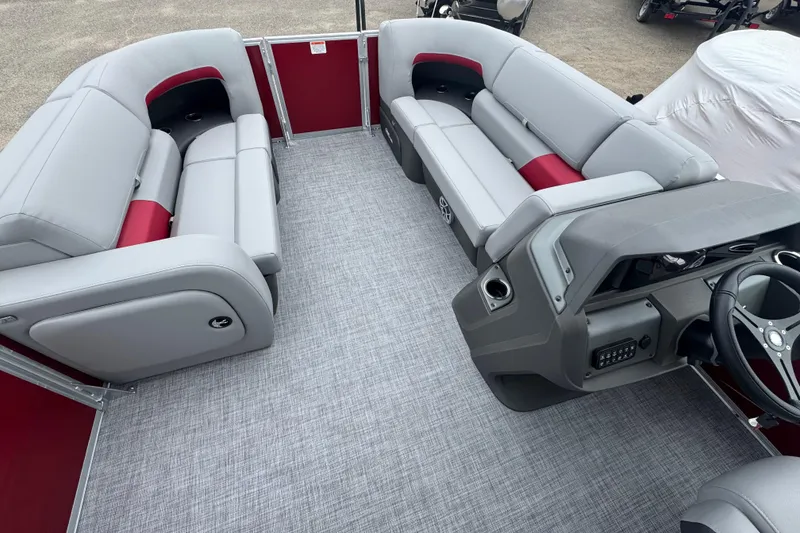 Slide: The Image of 2026 Sun Tracker Party Barge 22 RF DLX interior with gray and red seating, modern helm. - 8