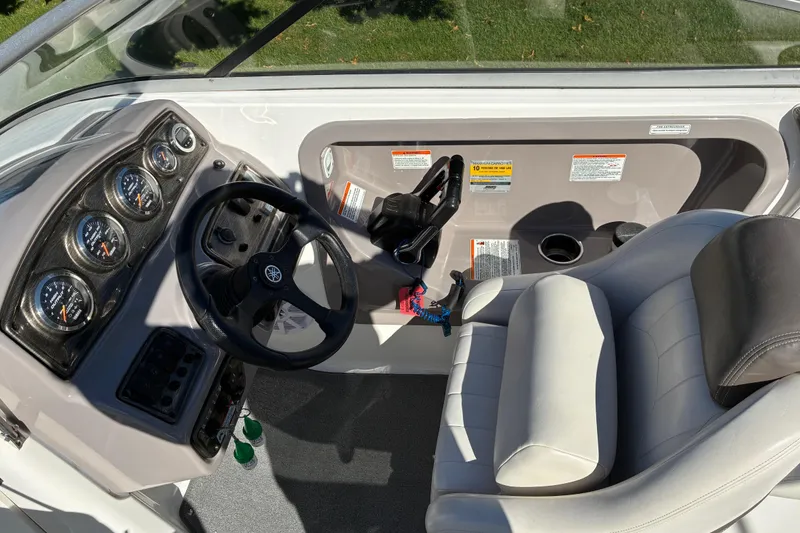 Slide: The Image of 2007 Yamaha Boats SX230 cockpit with steering wheel, gauges, and comfortable seating. - 12