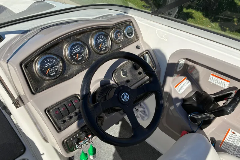 Slide: The Image of 2007 Yamaha Boats SX230 dashboard with steering wheel and instrument panel. - 13