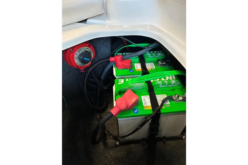 Slide: The Image of 2007 Yamaha Boats SX230 battery compartment with dual green batteries and power switch. - 23