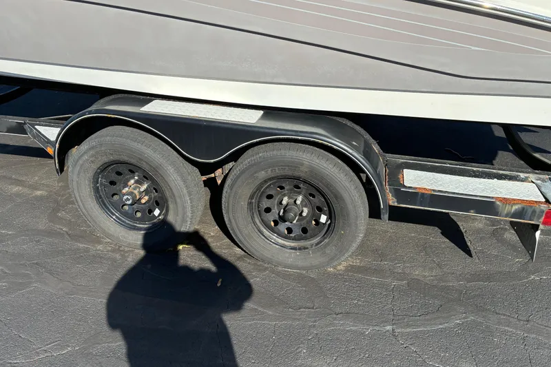 Slide: The Image of Trailer for 2007 Yamaha Boats SX230 with dual wheels on asphalt. - 5