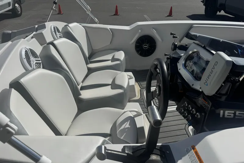 Slide: The Image of Interior of a 2018 Scarab 165 G boat with seating and dashboard. - 10