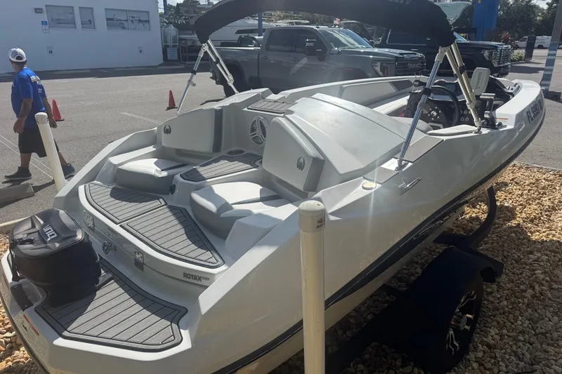 Slide: The Image of 2018 Scarab 165 G boat on trailer in parking lot, rear view. - 11