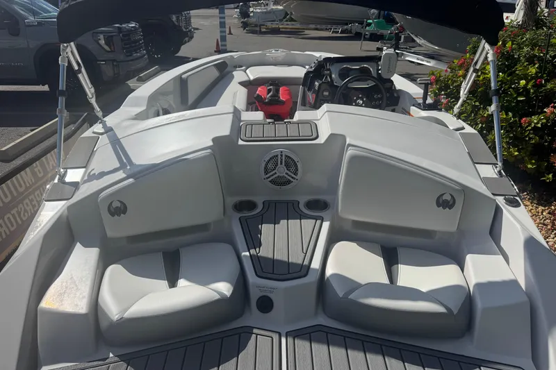 Slide: The Image of 2018 Scarab 165 G boat interior with seating and steering console. - 13