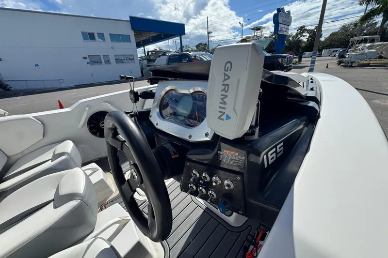 Slide: The Image of Interior of 2018 Scarab 165 G boat with Garmin navigation system and steering wheel. - 8