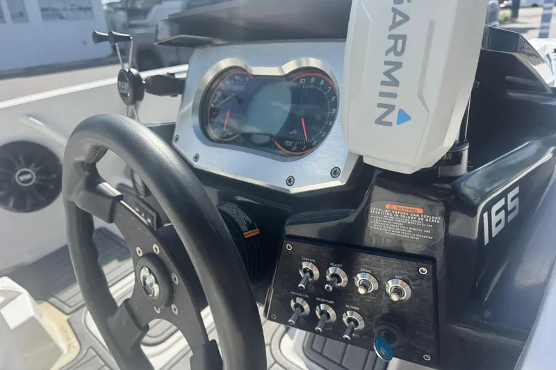Slide: The Image of Steering console of 2018 Scarab 165 G boat with Garmin navigation system. - 9