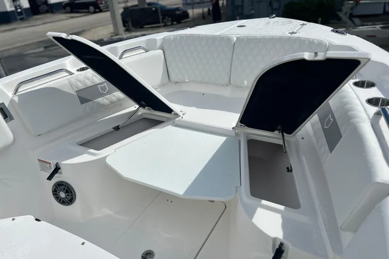 Slide: The Image of 2026 Sea Fox 268 Commander boat interior with open storage compartments and cushioned seating. - 12
