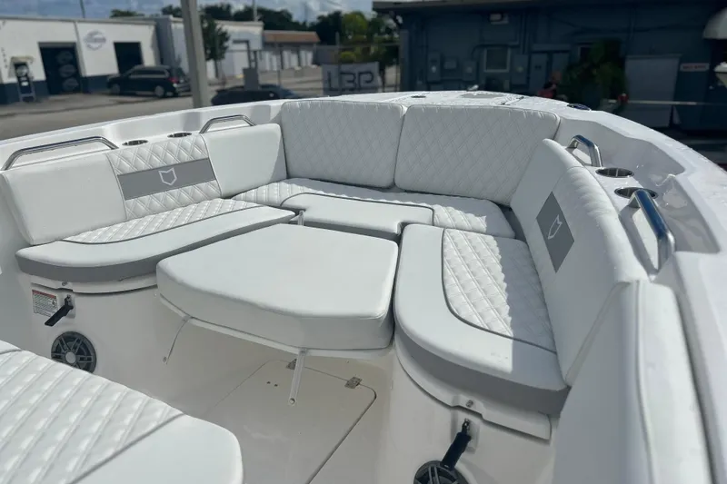 Slide: The Image of 2026 Sea Fox 268 Commander boat interior with white cushioned seating and cup holders. - 15