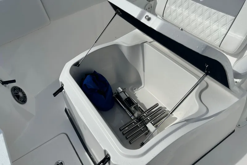 Slide: The Image of Storage compartment on 2026 Sea Fox 268 Commander boat, featuring a blue bag and metal accessories. - 18