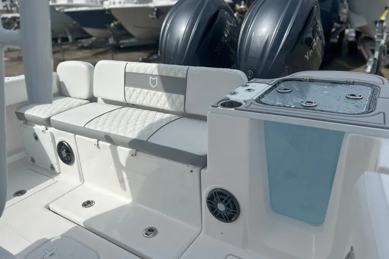 Slide: The Image of 2026 Sea Fox 268 Commander boat interior with cushioned seating and dual engines. - 24