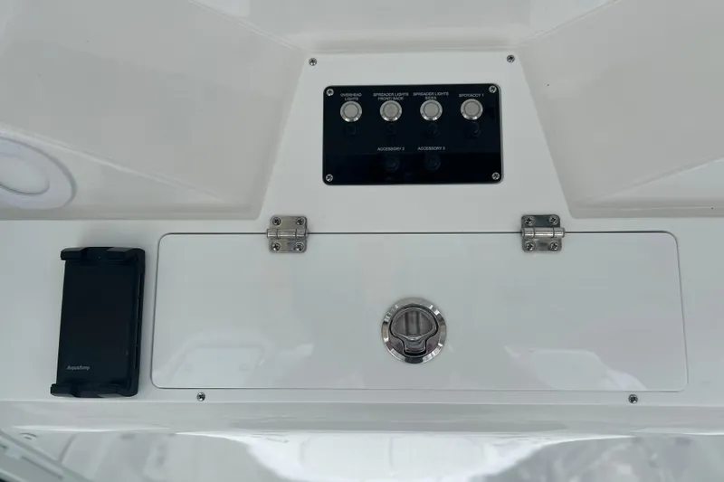 Slide: The Image of Control panel of 2026 Sea Fox 268 Commander boat with switches and storage compartment. - 26