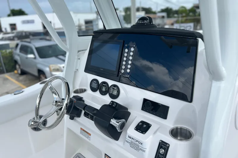 Slide: The Image of Dashboard of 2026 Sea Fox 268 Commander boat with steering wheel and controls. - 3