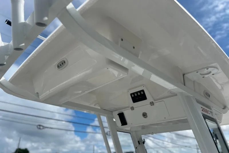 Slide: The Image of 2026 Sea Fox 268 Commander boat's overhead console and storage compartments under clear sky. - 31
