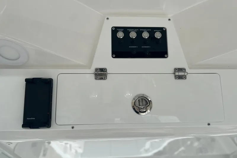 Slide: The Image of Control panel of 2026 Sea Fox 268 Commander boat with switches and storage compartment. - 32