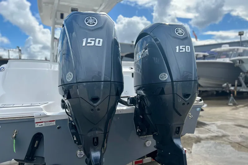 Slide: The Image of 2026 Sea Fox 268 Commander with dual Yamaha 150 outboard engines, docked under a cloudy sky. - 37