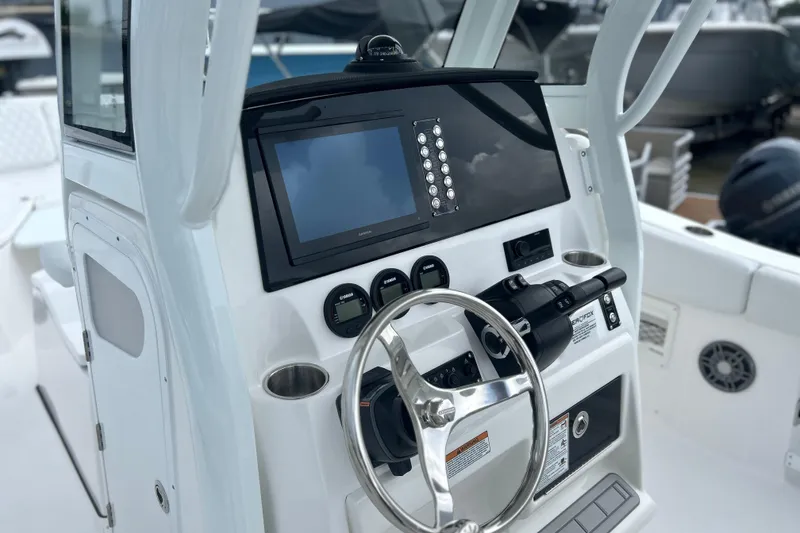 Slide: The Image of 2026 Sea Fox 268 Commander boat dashboard with steering wheel and navigation display. - 4
