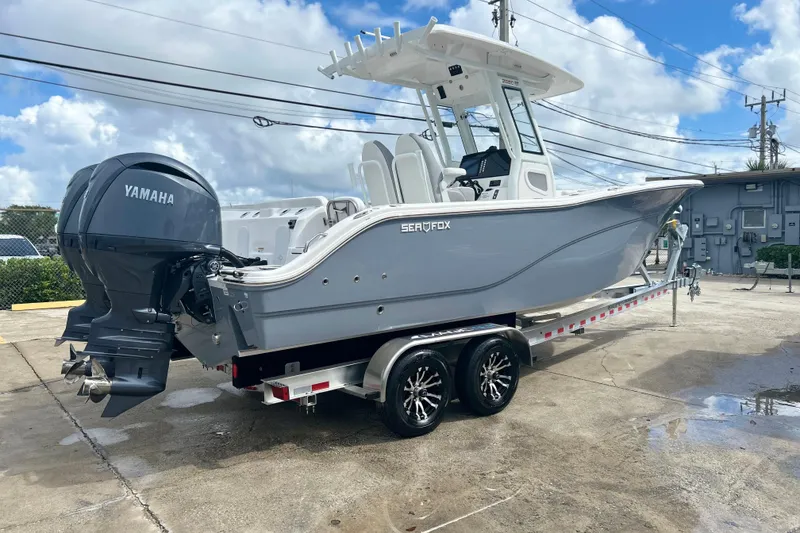 Slide: The Image of 2026 Sea Fox 268 Commander boat on trailer with Yamaha engine, parked outdoors. - 44
