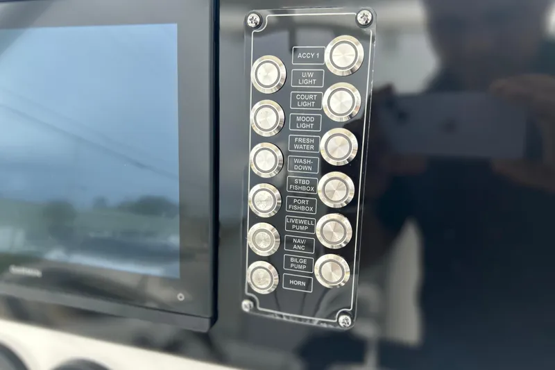 Slide: The Image of Control panel of 2026 Sea Fox 268 Commander boat with labeled buttons and display screen. - 6