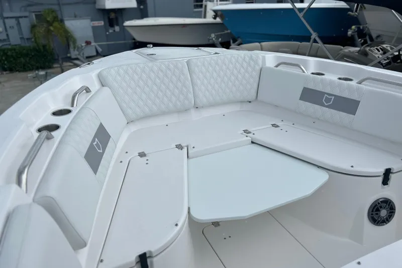 Slide: The Image of 2026 Sea Fox 268 Commander boat interior with white seating and table. - 9