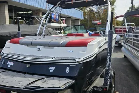 Slide: The Image of 2017 MasterCraft NXT20 boat with red and gray seating, displayed outdoors. - 6