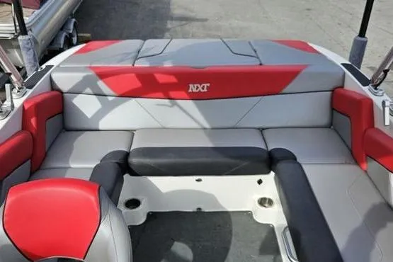 Slide: The Image of 2017 MasterCraft NXT20 boat interior with red and gray seating. - 7