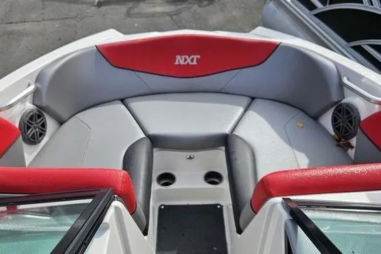 Slide: The Image of 2017 MasterCraft NXT20 boat interior with red and gray seating and speaker system. - 8