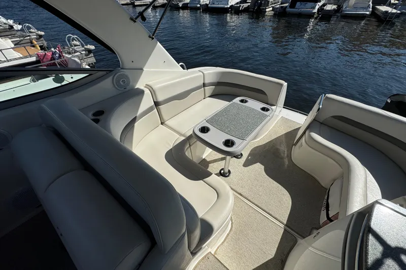 Slide: The Image of 2007 Chaparral Signature 330 boat interior with seating and table, docked at marina. - 14