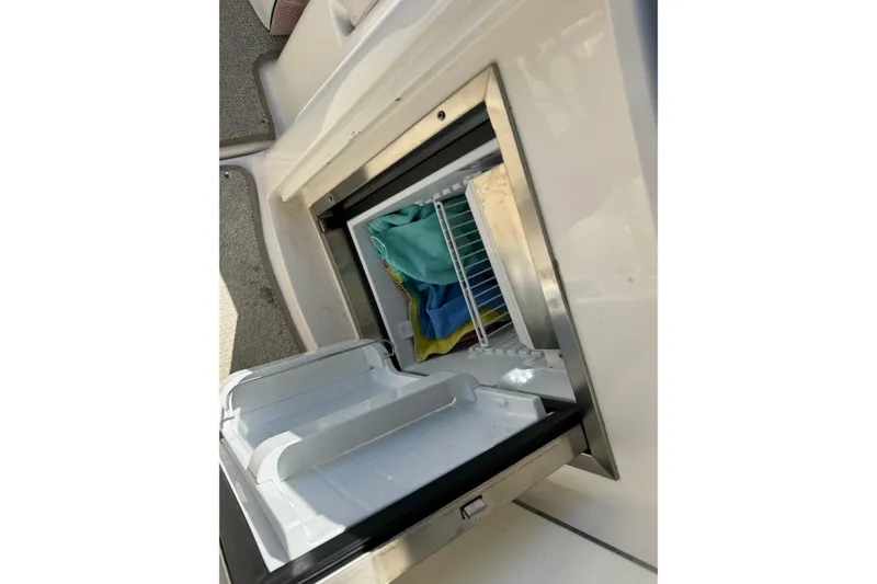 Slide: The Image of Open refrigerator on 2007 Chaparral Signature 330 boat, showing interior storage. - 16