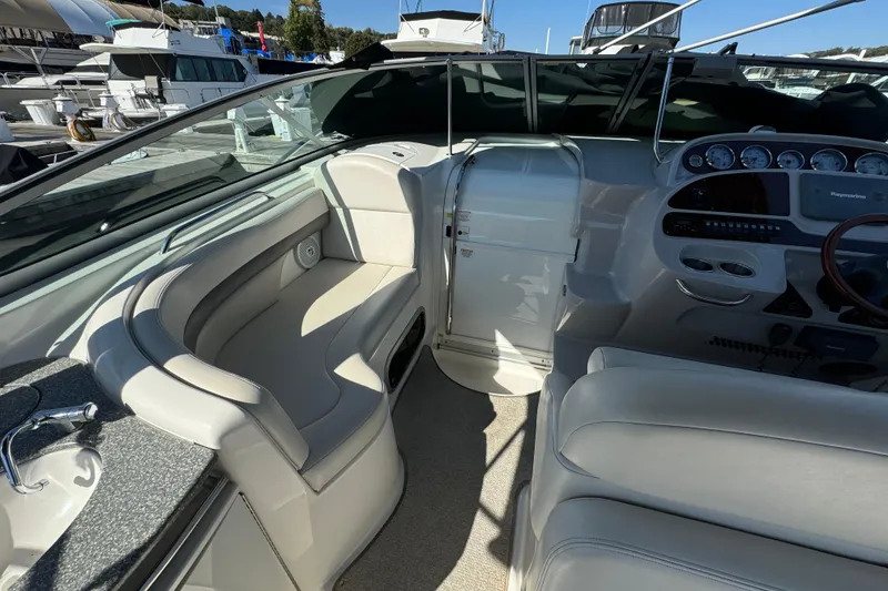 Slide: The Image of 2007 Chaparral Signature 330 boat interior with seating and control panel at a marina. - 18