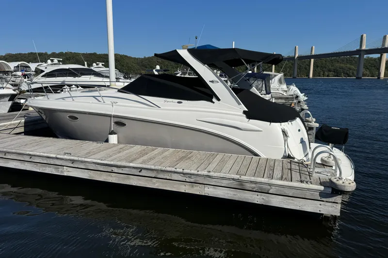 Slide: The Image of 2007 Chaparral Signature 330 boat docked at marina with bridge in background. - 2