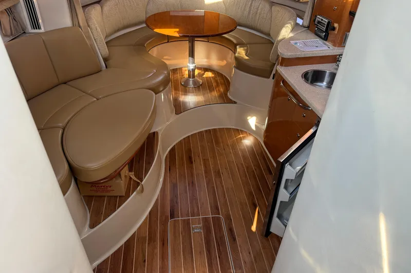 Slide: The Image of 2007 Chaparral Signature 330 interior with wood flooring, leather seating, and compact kitchenette. - 20