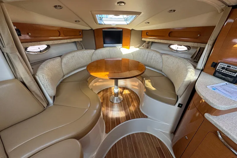 Slide: The Image of Luxurious interior of 2007 Chaparral Signature 330 yacht with elegant seating and wooden table. - 22
