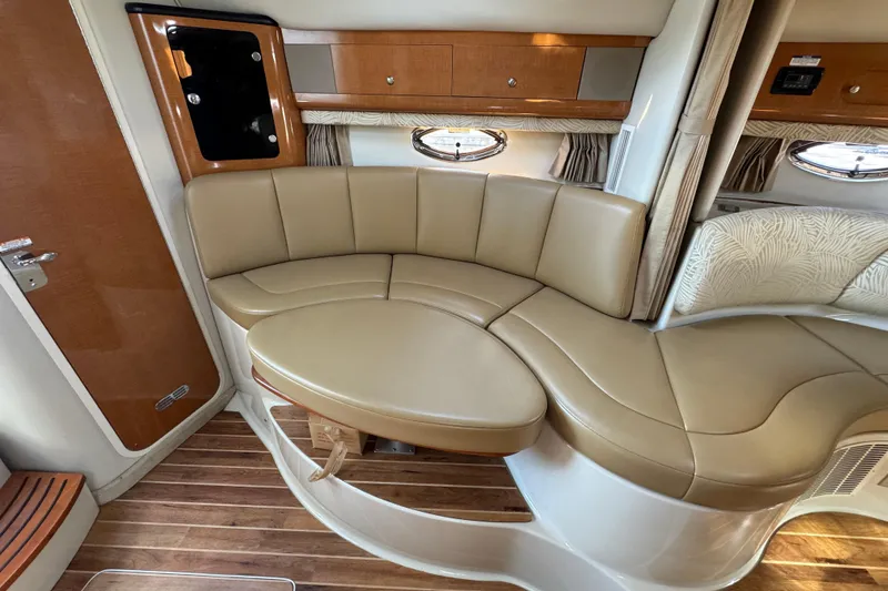 Slide: The Image of 2007 Chaparral Signature 330 interior with beige leather seating and wood accents. - 25